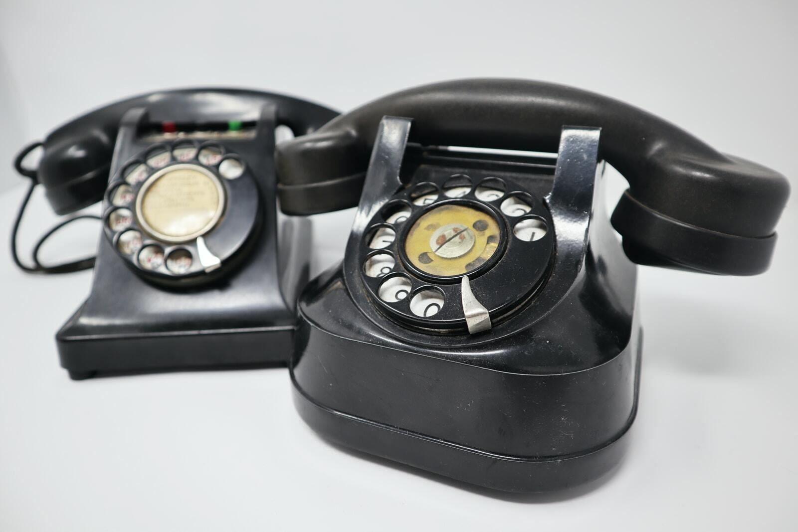 two black rotary telephones
